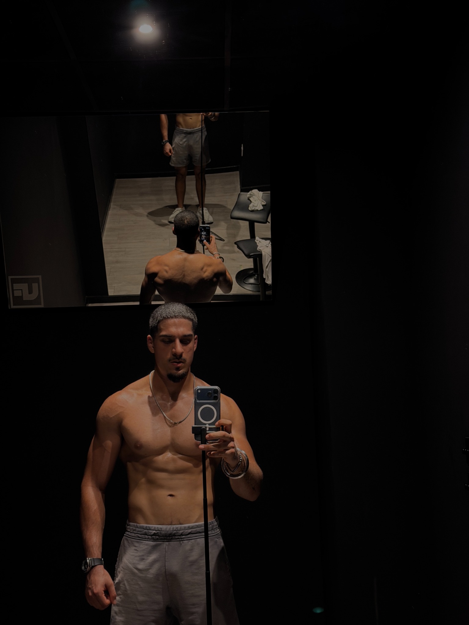 Haridev showing his later physique progress in a gym mirror